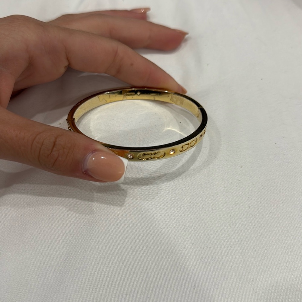 Used COACH hinged bangle, not missing any diamonds